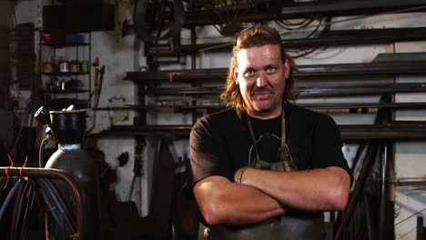 welder standing with arms crossed