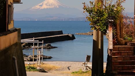 Beautiful-cinematic-reveal-of-Mount-Fuji-from-small-alley-in-Japanese-seaside-town