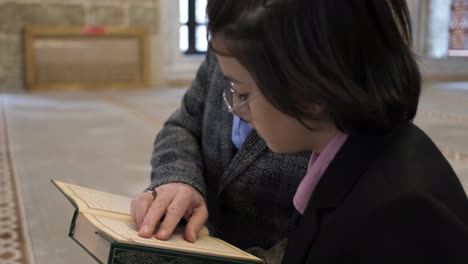 man teaching quran