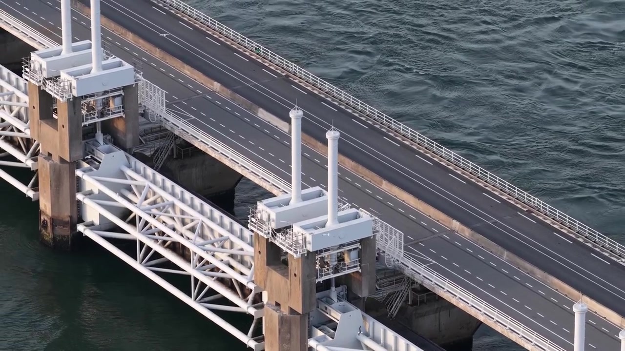 Aerial view of the Oosterscheldekering, showing the Dutch storm surge barrier, Delta Works engineering, flood protection and coastal road infrastructure.