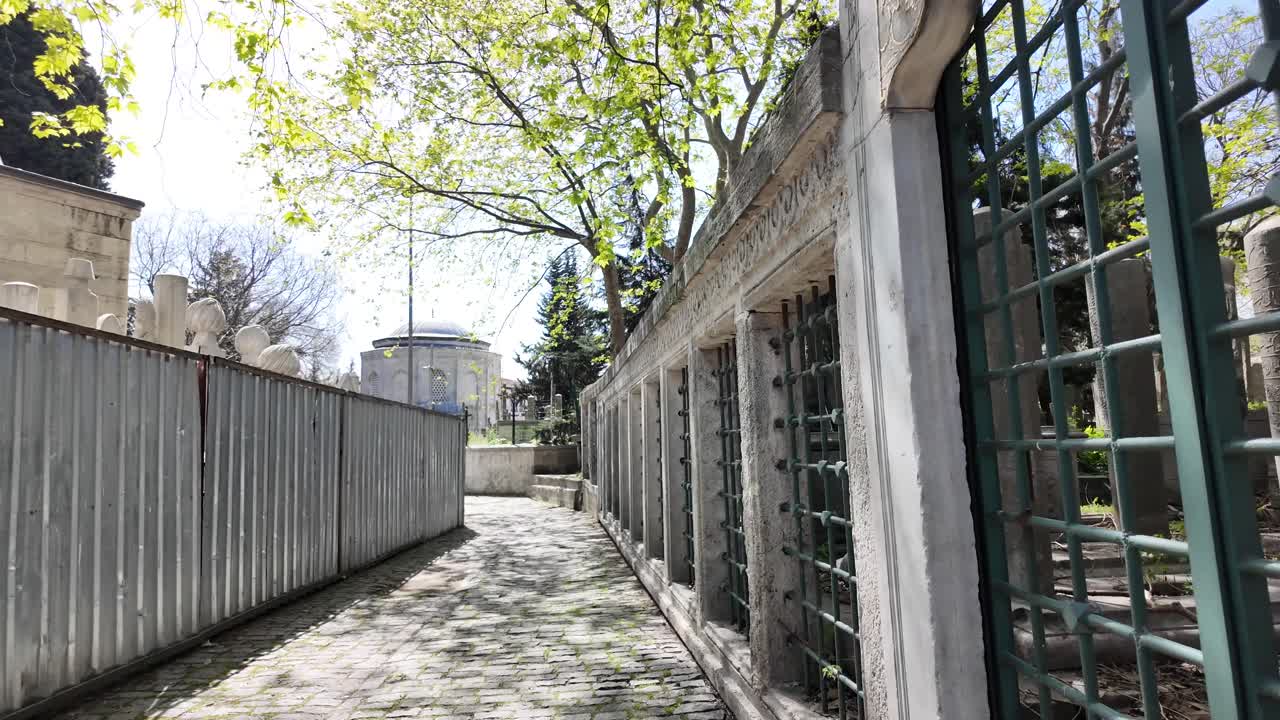 A historic Islamic cemetery with tombs and a dome-topped building