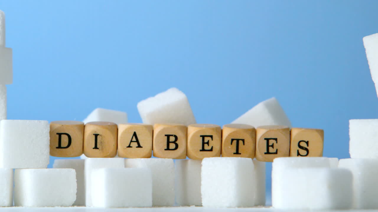 Terrones de azúcar y dados formando la palabra diabetes cayendo