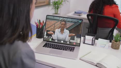 Biracial-businesswoman-using-laptop-for-video-call-with-african-american-business-colleague