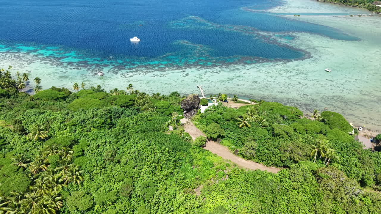 Finger of God Rock and Tropical Lush of Bora Bora Island, French Polynesia, Drone Aerial View