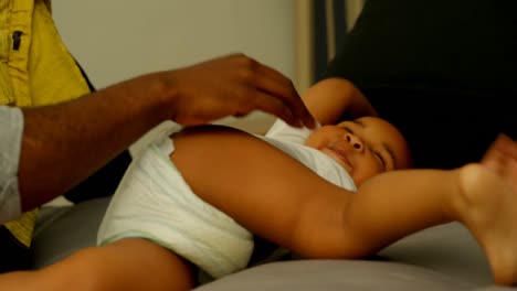 Close-up-of-black-father-playing-with-his-son-on-bed-in-bedroom-of-comfortable-home-4k