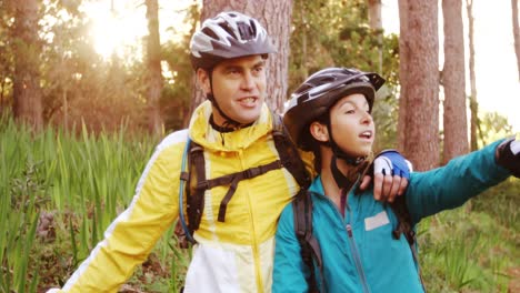 mountain biking couple pointing at nature