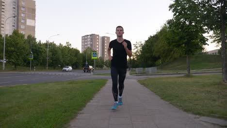 slow motion shot of young slim man running outside