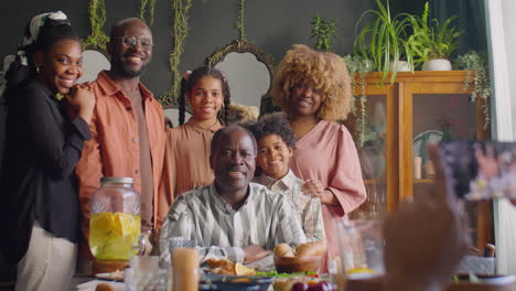 happy african american family posing for photo at home dinner