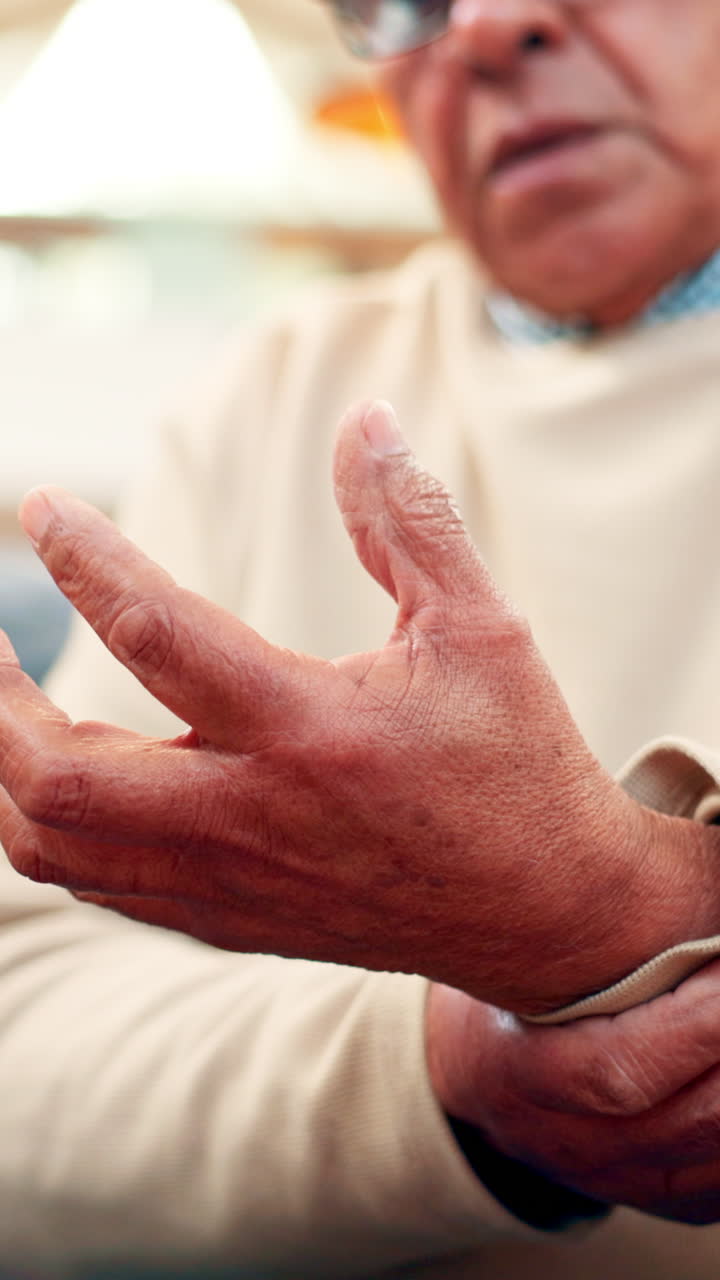 Close-up of Elderly Man's Hands Moving with Discomfort