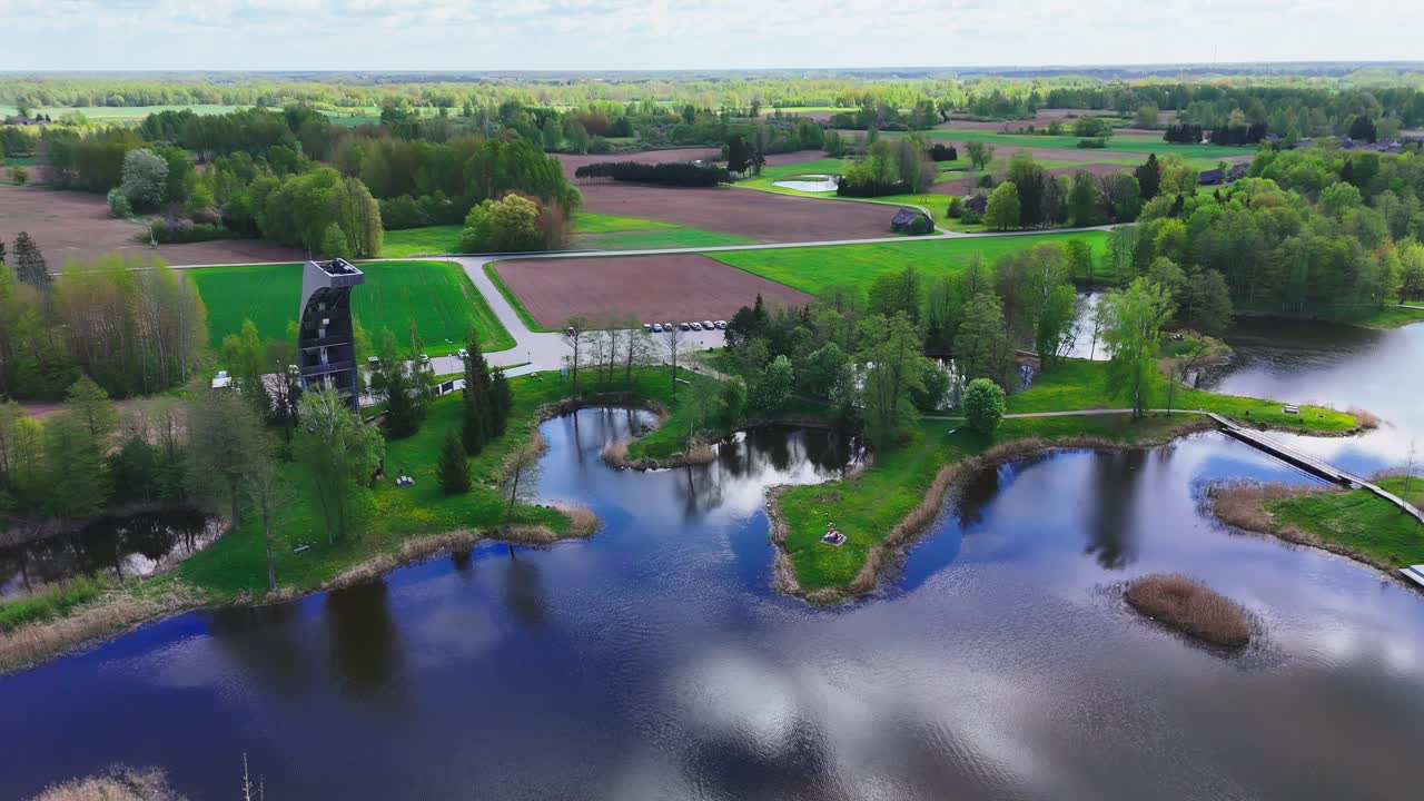 Kirkilai Observation Tower, Biržai Regional Park, Lithuania - A Beautiful View Highlights Winding Walkways, Peaceful Karst Lakes, and Lush, Densely Wooded Areas - Aerial Pullback Shot