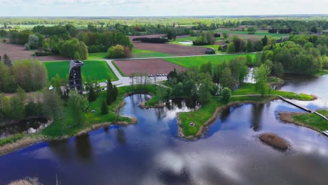 kirkilai observation tower, biržai regional park, lithuania - a beautiful view highlights winding walkways, peaceful karst lakes, and lush, densely wooded areas - aerial pullback shot