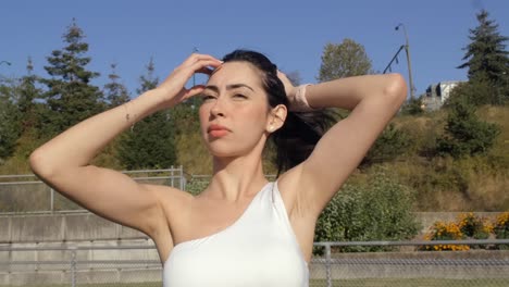 Portrait of Sporty Girl Tying Up Her Hair - Close Up Parallax