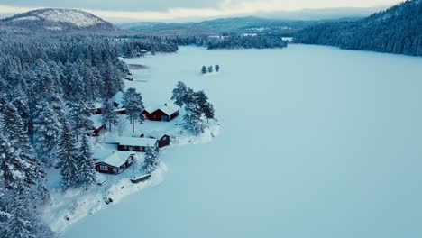 panoramic frozen lake mountain forest in a rural village in norway