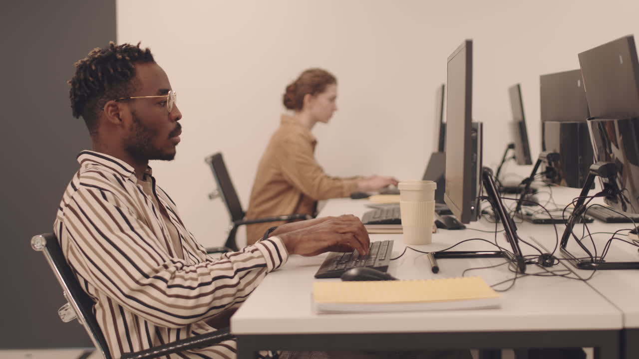 Afro American Programmer Typing on Computer
