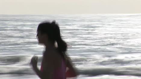 woman on beach jogging