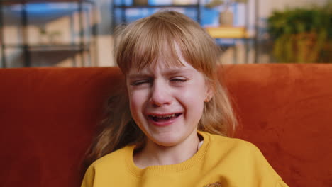 upset punished offended child girl kid crying with tears at home quarrel abuse bullying violence