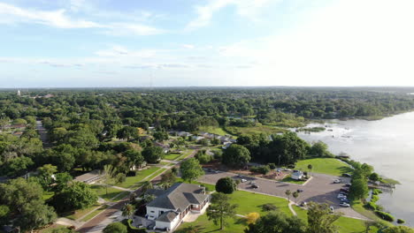 flying over a lakeside park during an early spring sunset