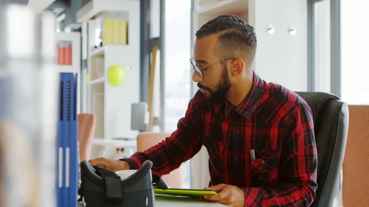 Male graphic designer using digital tablet at desk 4k