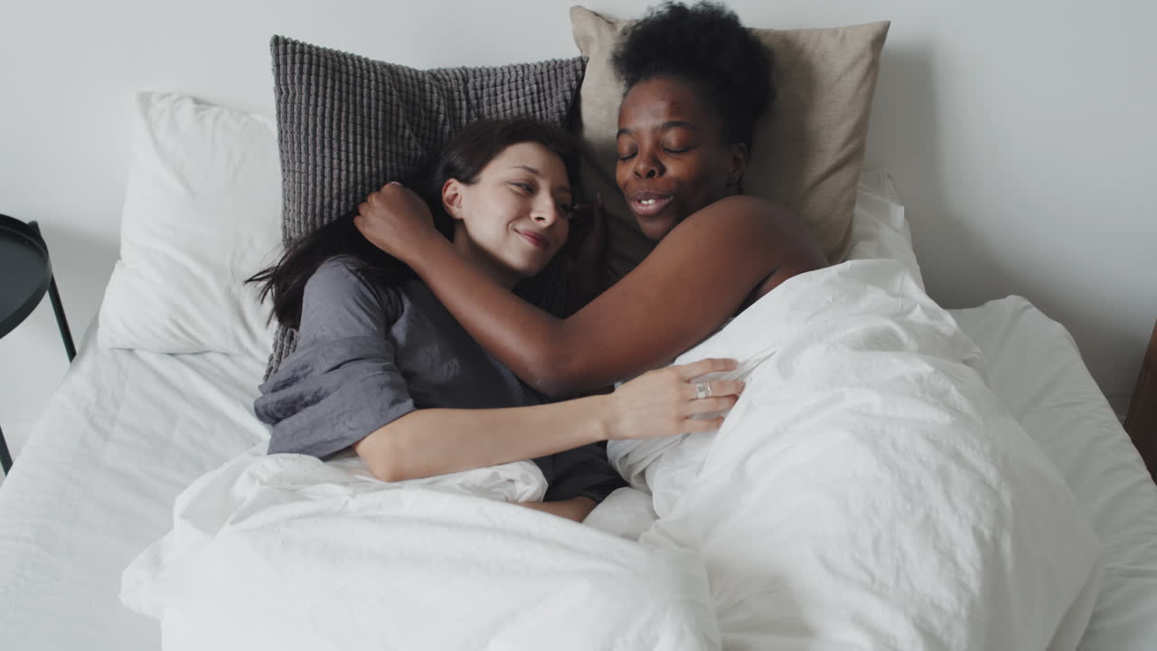 Female Couple Waking Up in Morning