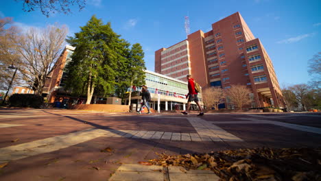 people walking by the main library building of north carolina state university in raleigh, nc on a sunny day. low-level, timelapse