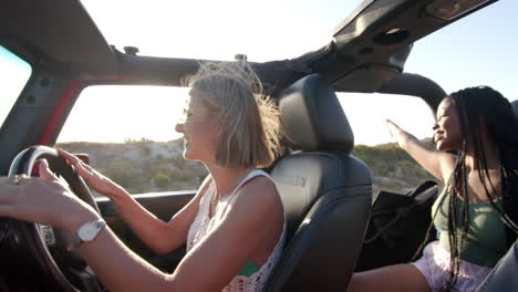 young caucasian woman drives a convertible on a road trip