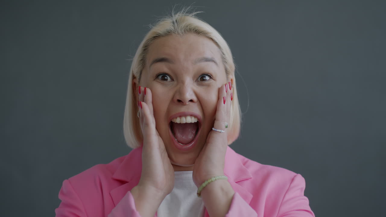Excited Woman in Pink Blazer