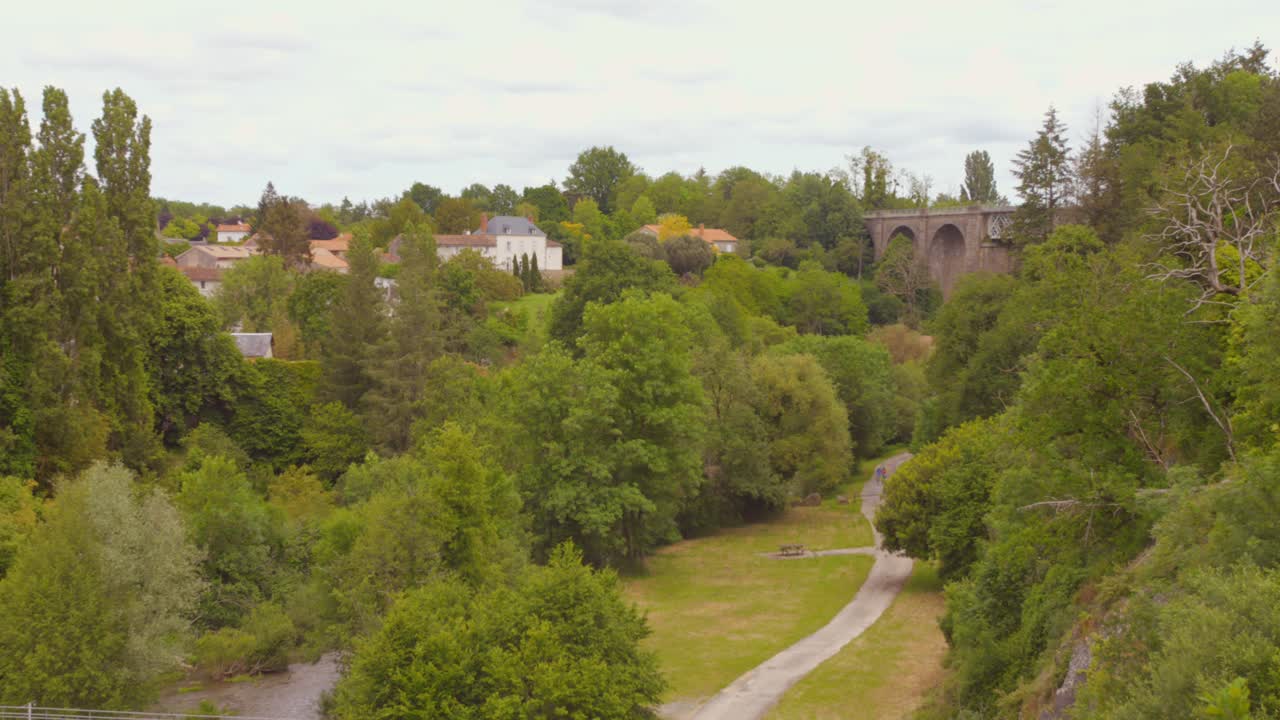 Picturesque Countryside Landscape with Stone Bridge and River