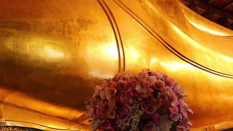 golden buddha statue with floral decorations