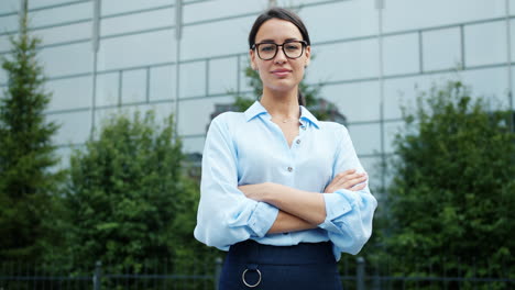 confident businesswoman in front of a modern building