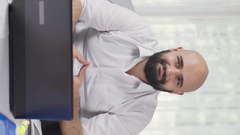 Vertical-video-of-Home-office-worker-man-nods-to-the-camera.