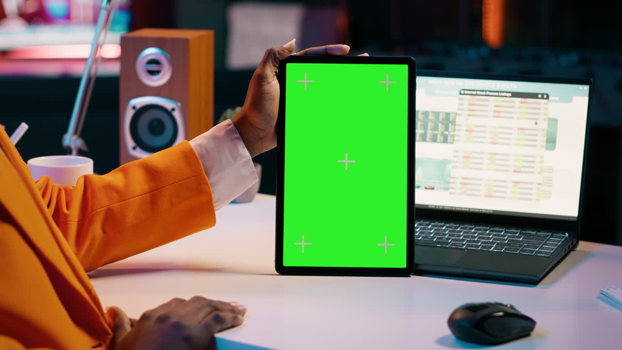 African american girl holding tablet with greenscreen layout