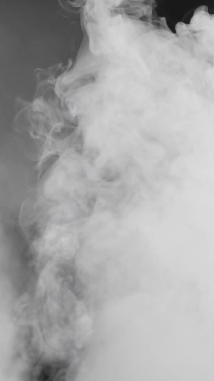 Vertical billowing white smoke rises from bottom corner on black. Ideal for social media overlays, transitions, and atmospheric effects