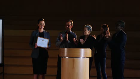 Female-business-executive-receiving-award