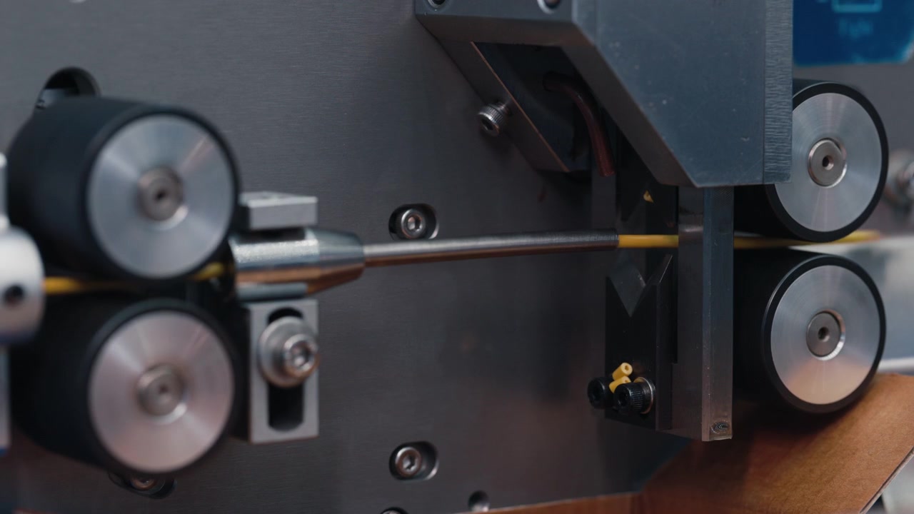 Automated Industrial Machine Cutting Yellow Cable