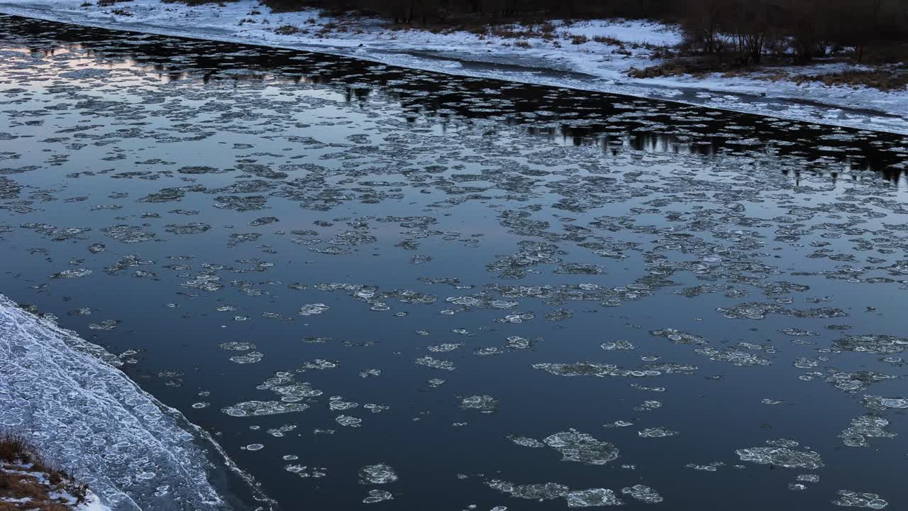 Beautiful river with flowing ice, aerial view