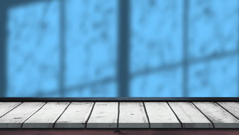animación de hojas y sombras de ventanas sobre fondo azul y de madera
