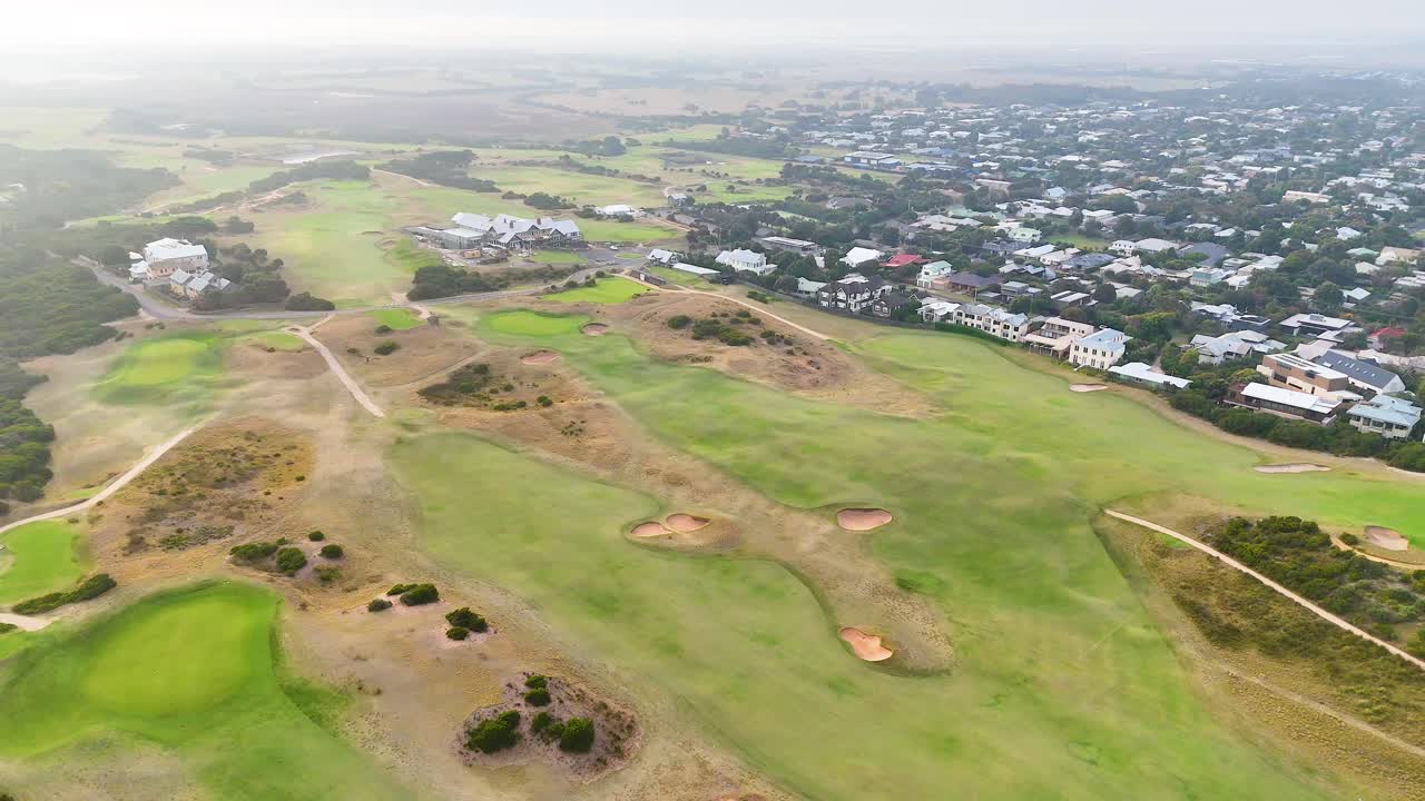 Drone footage captures expansive views of Barwon Heads golf course under soft, natural lighting with surrounding residential area