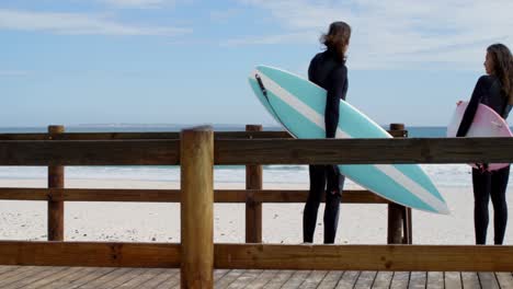 Couple-interacting-with-each-other-on-wooden-walkway-4k