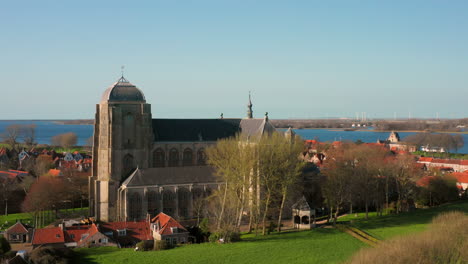 Aerial:-The-historical-town-of-Veere-with-an-old-harbour-and-churches,-on-a-spring-day