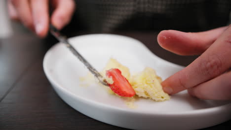 eating small fruit cakes on a plate