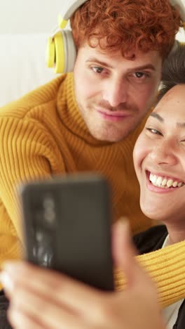 joyful couple or friends taking playful selfies