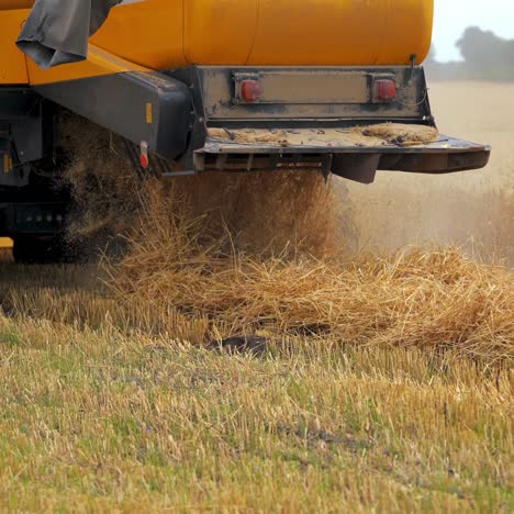 selective focus on harvesting machinery detail. heavy machinery is working the field
