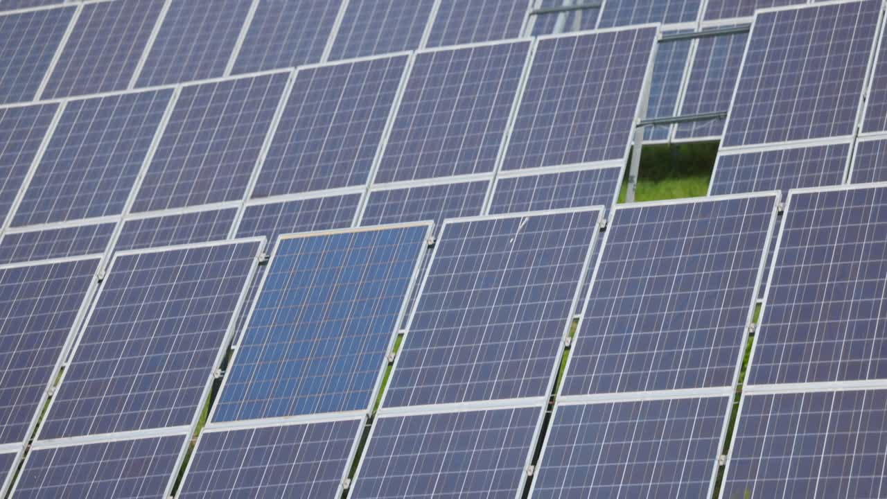 Solar panel farm in green field. Renewable energy technology for sustainable power generation. Aerial