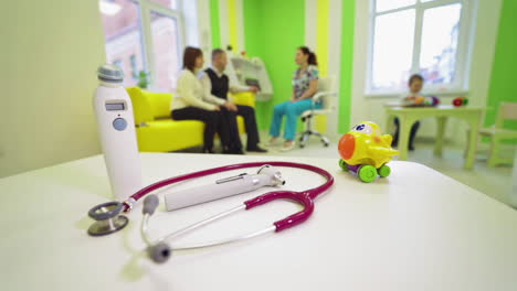 happy family at pediatrician. family visiting and listening to medical prescription
