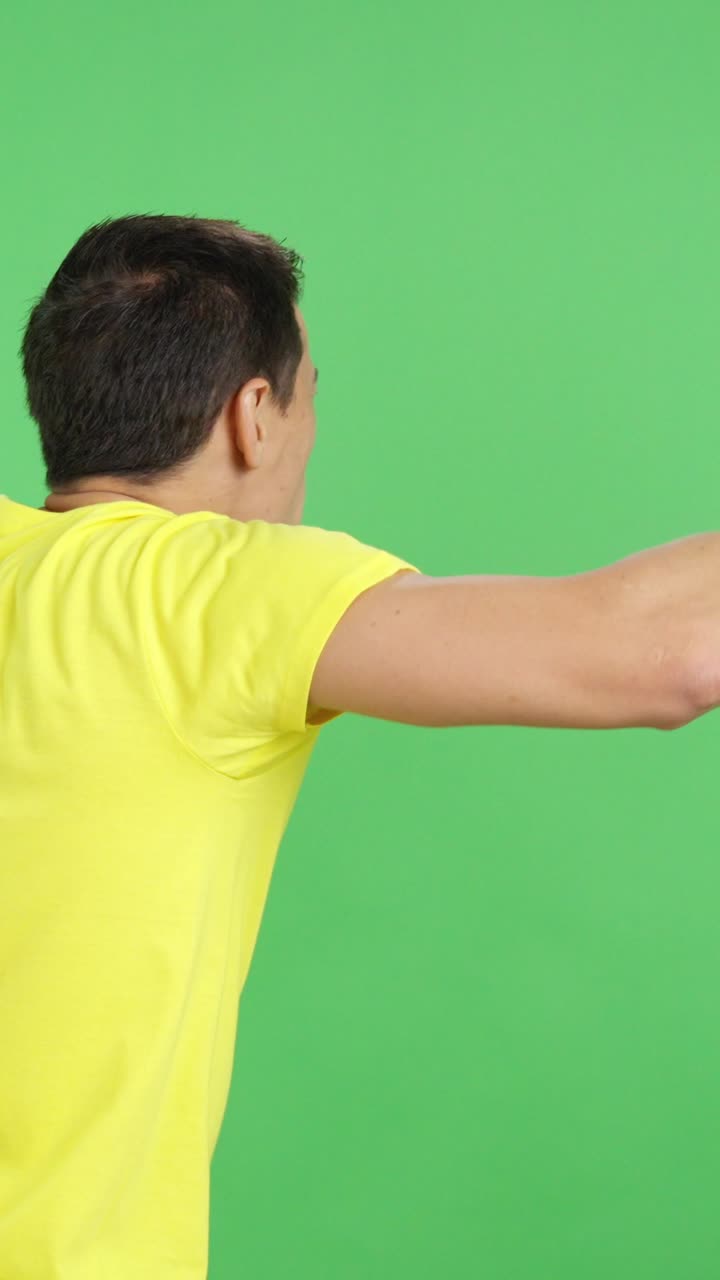 Rear view of a man waving a ecuadorian pennant