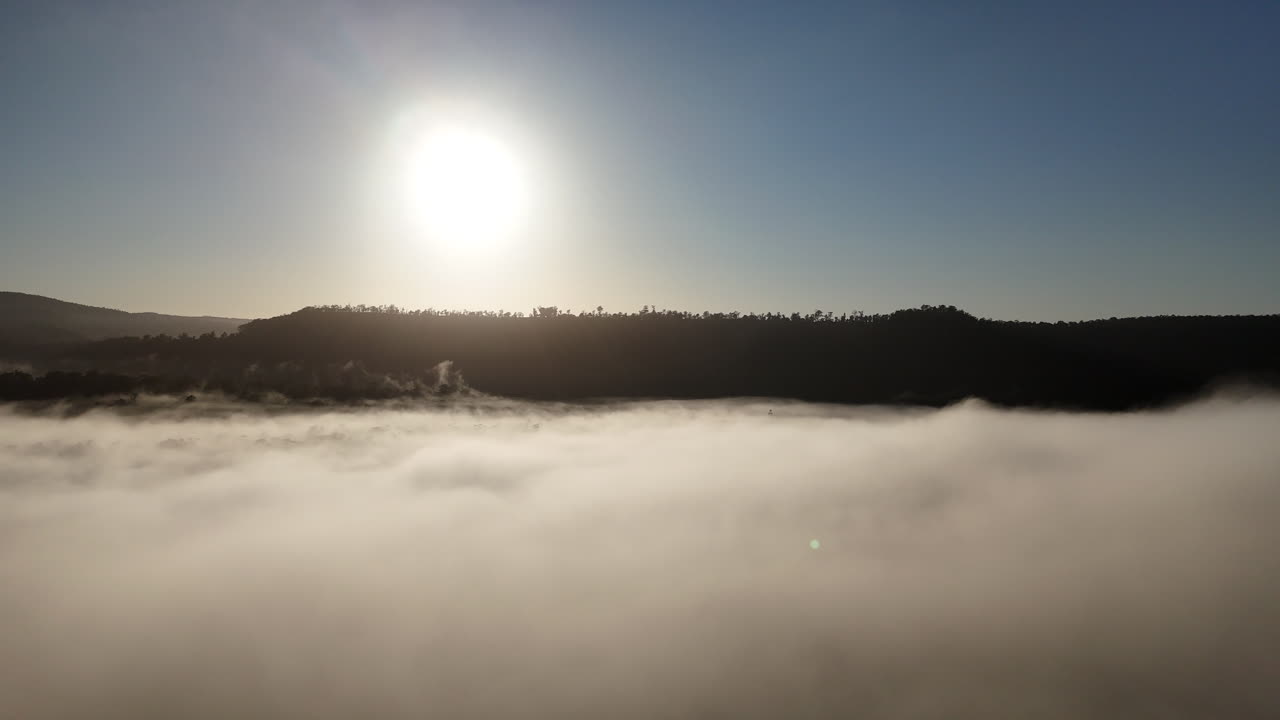 Experience the breathtaking views from high above the clouds as the sun shines brightly. This aerial adventure showcases the serene beauty of nature and the landscapes below.