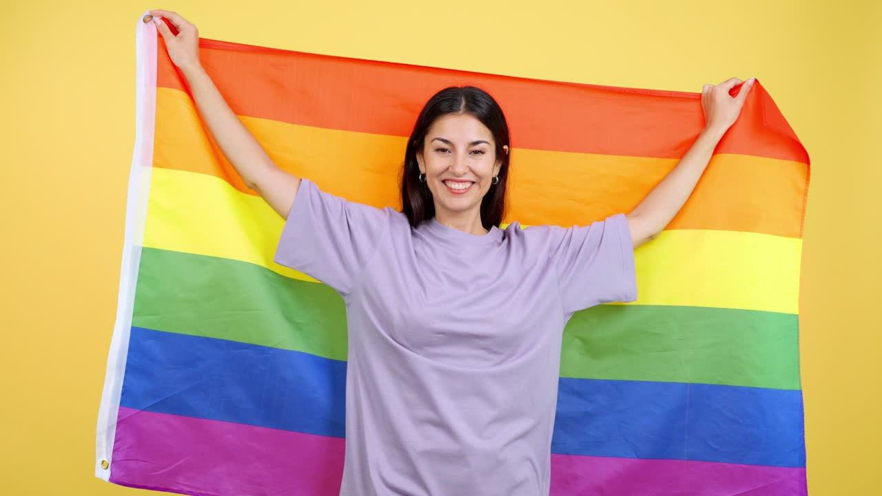 Happy Woman Celebrating with LGBTQ+ Rainbow Flag