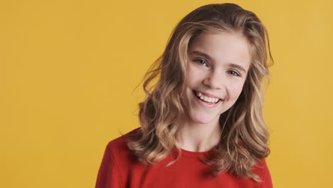 teenage caucasian girl smiling in front of the camera.