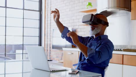 Senior-man-using-virtual-reality-headset-in-kitchen-4k