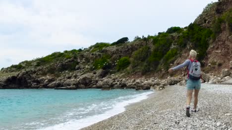 woman hiking on a pebble beach